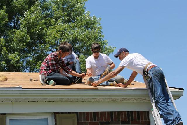 Volunteers began repairing the roof at a home in Campbellsville during KHO's Summer Repair Program. From left are: Frank Fersch of East Newnan Baptist Church in Newnan, Ga., Zach Crewse with Orange United Methodist Church in Chapel Hill, N.C., Chandler Riggs with Hillside United Methodist Church in Woodstock, Ga., and Jade Rouse with East Newnan Baptist Church in Newnan, Ga. Their crew leader (not pictured) was Chris Barton, a CU alumnus. (Photo by Lauren Barr) 