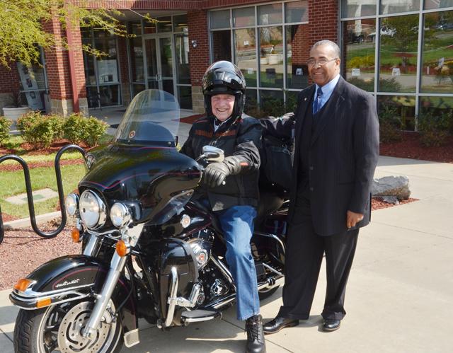 Dr. Joseph Owens, left, chair of the Campbellsville University Board of Trustees, visits with Dr.  E. Bruce Heilman, member of the trustees, as he continues his 6,000 mile trip on his Harley-Davidson. (Campbellsville University Photo by Joan C. McKinney)