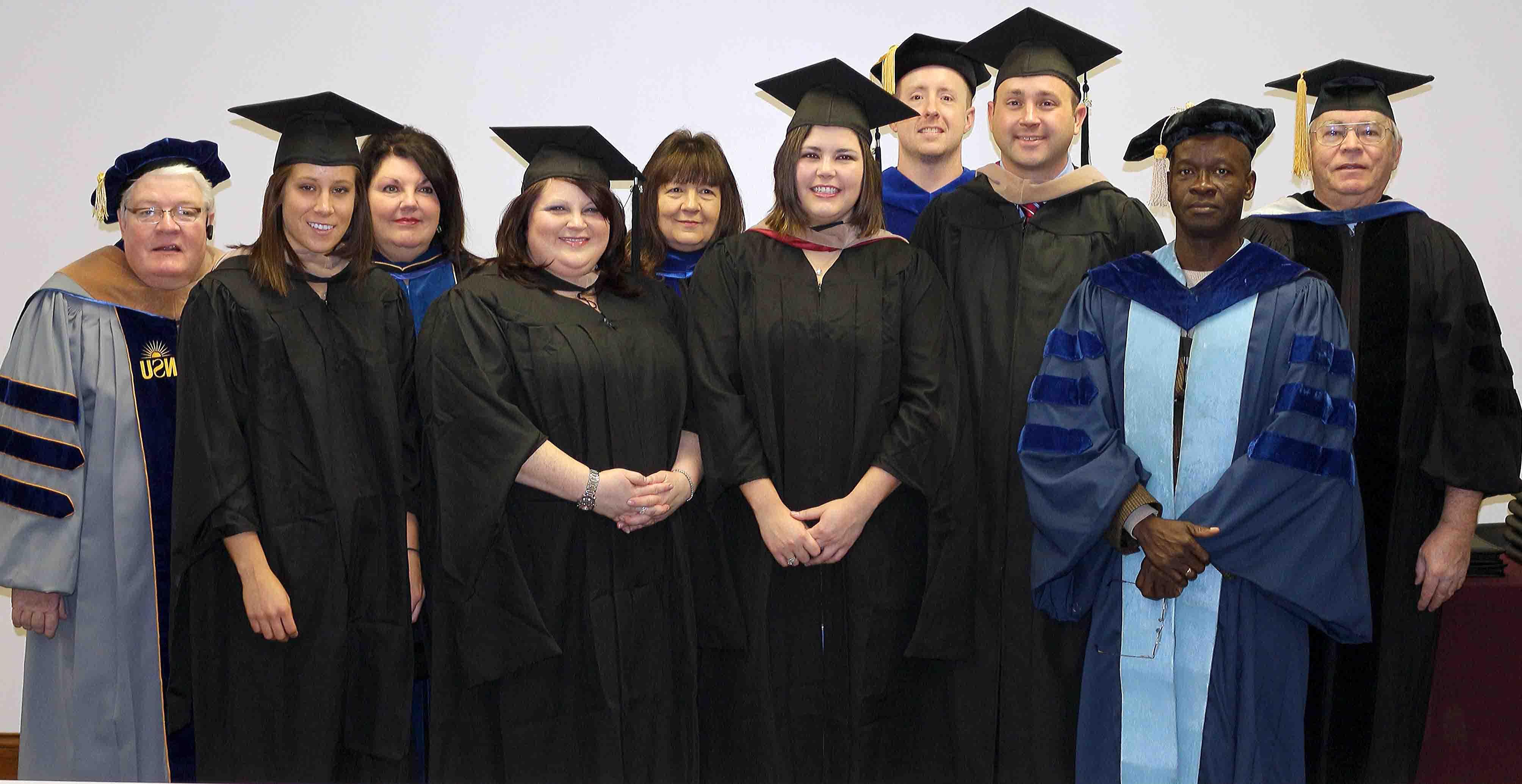 Campbellsville University’s School of Business and Economics held a hooding ceremony for their graduate students on Dec. 12 in the Administration Building on campus. From left - Dr. Vernon Roddy, professor of economics; Dr. Sunny Onyiri, professor of business and accounting; Jason England of Campbellsville, Ky., director of the Big Maroon Club, graduating with a degree in business administration; Dr. Bill Adams, assistant professor of business; Virginia McNutt of Nicholasville, Ky., graduating with a degree in organizational leadership; Dr. Pat Cowherd, dean of the School of Business and Economics; Amanda Efird of Louisville, Ky., organizational leadership; Dr. Karan Rush, assistant professor of business; Katie White of Summerside, Prince Edward, Canada, graduating with a degree in business administration; and Dr. Richard Corum, associate dean and professor of business administration. (Campbellsville University Photo by Allye Hamilton)